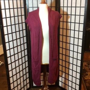 Maurice’s maroon long sweater vest.